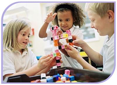 Able kids therapy Allied Health Services - Paediatric Occupational Therapy & speech therapy. A group of children sit on the floor playing with colourful connector blocks working as a team.